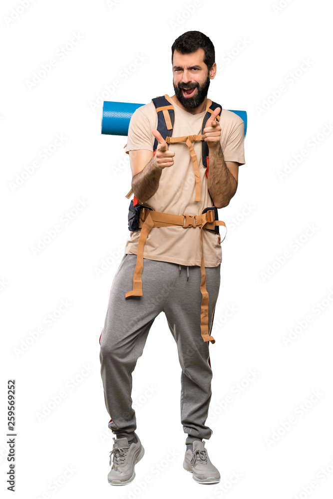 Hiker man pointing to the front and smiling over isolated white background Hiker man pointing to the front and smiling over isolated white background
