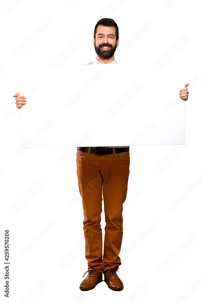 Happy Handsome man with beard holding an empty placard Happy Handsome man with beard holding an empty placard