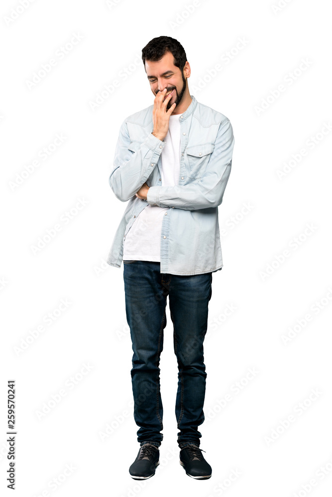 Full-length shot of Handsome man with beard smiling a lot over isolated white background Full-length shot of Handsome man with beard smiling a lot over isolated white background