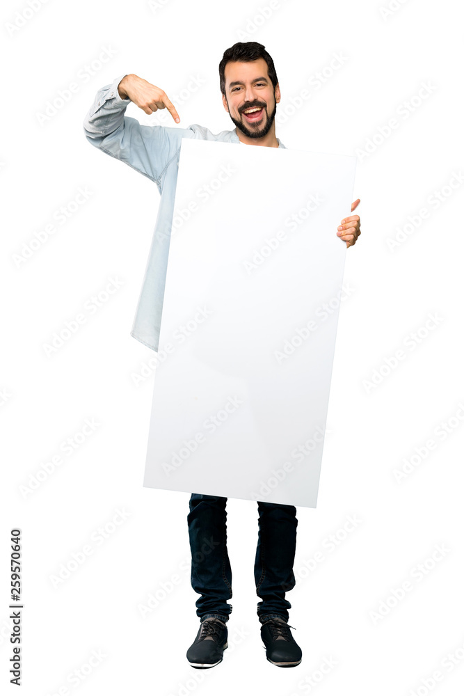 Handsome man with beard holding an empty placard Handsome man with beard holding an empty placard