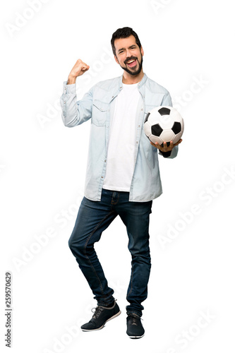 Handsome man with beard holding a soccer ball