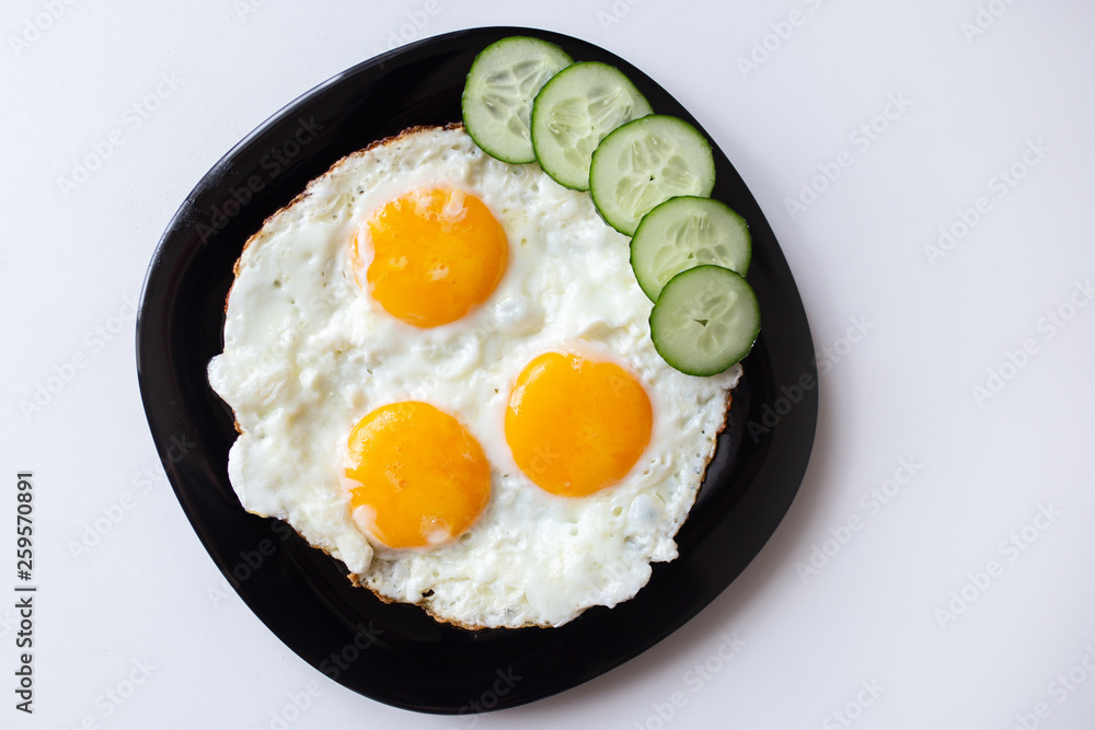 Breakfast. Fried eggs with bread and cucumbers Breakfast. Fried eggs with bread and cucumbers