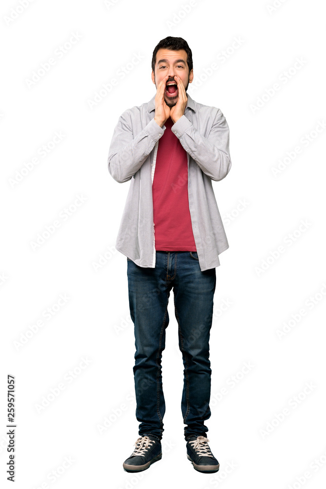 Full-length shot of Handsome man with beard shouting and announcing something over isolated white background Full-length shot of Handsome man with beard shouting and announcing something over isolated white background