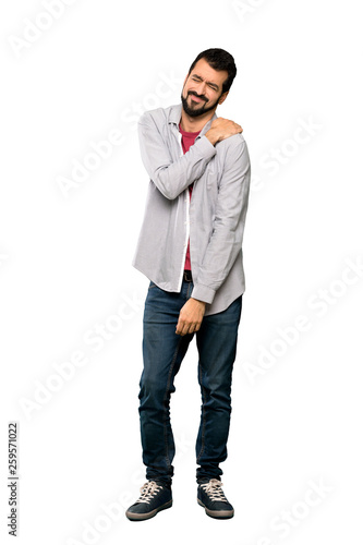 Full-length shot of Handsome man with beard suffering from pain in shoulder for having made an effort over isolated white background