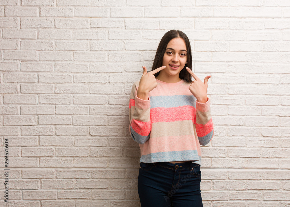 Young modern woman smiles, pointing mouth Young modern woman smiles, pointing mouth
