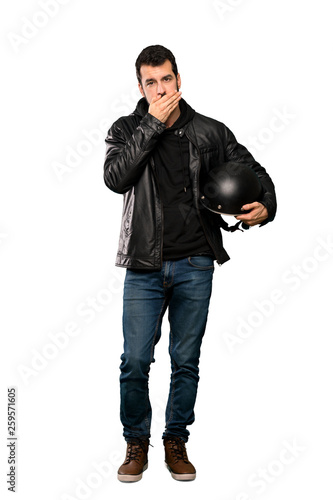 Full-length shot of Biker man covering mouth with hands over isolated white background