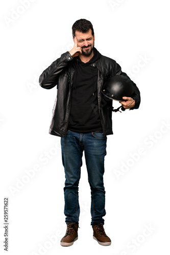 Full-length shot of Biker man with headache over isolated white background