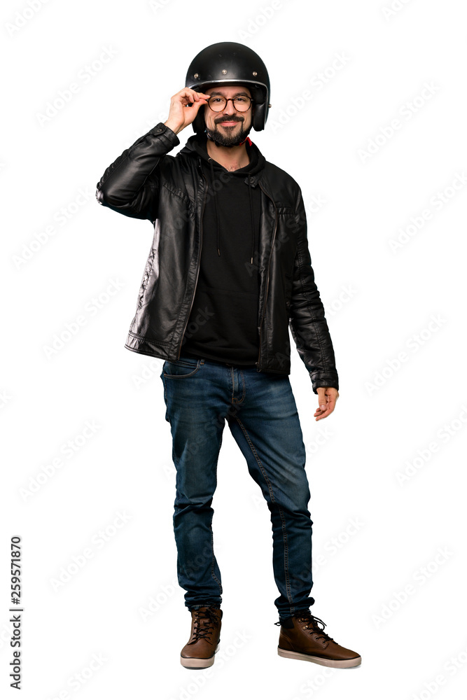 Full-length shot of Biker man with glasses and surprised over isolated white background Full-length shot of Biker man with glasses and surprised over isolated white background