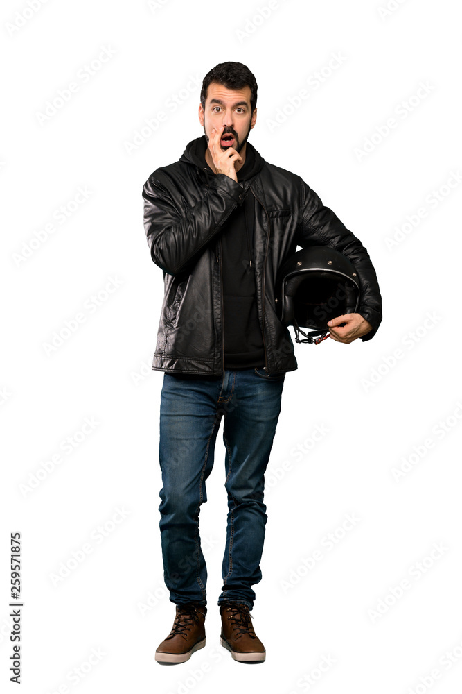 Full-length shot of Biker man surprised and shocked while looking right over isolated white background Full-length shot of Biker man surprised and shocked while looking right over isolated white background