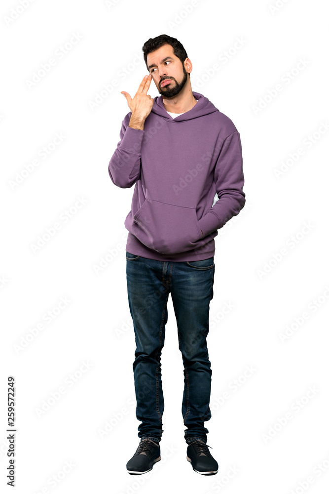 Full-length shot of Handsome man with sweatshirt with problems making suicide gesture over isolated white background Full-length shot of Handsome man with sweatshirt with problems making suicide gesture over isolated white background