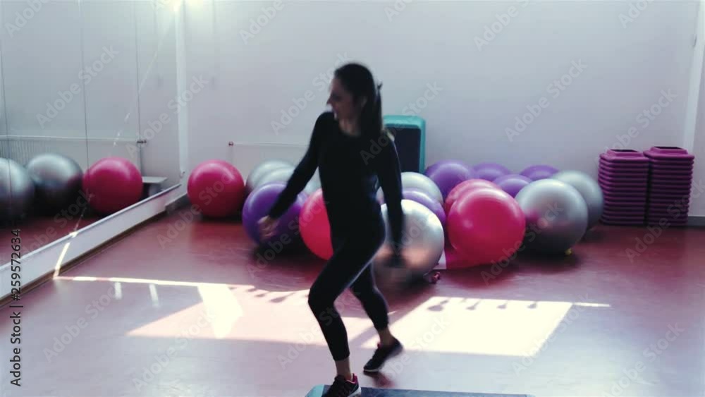 the girl is engaged in step aerobics the girl is engaged in step aerobics