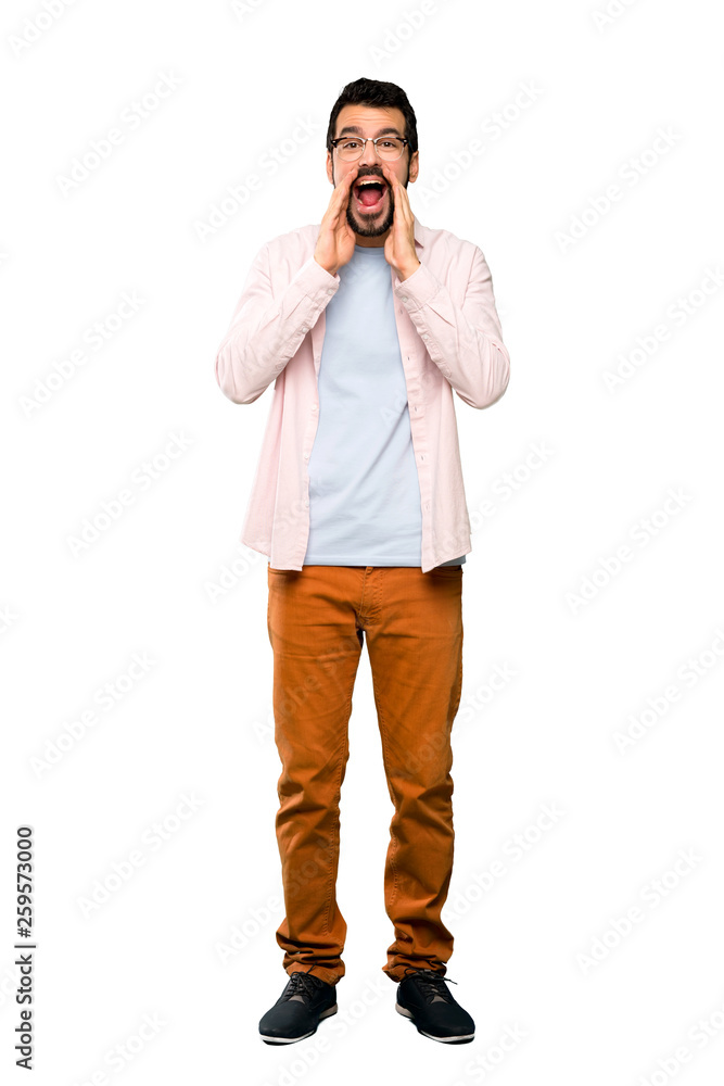 Full-length shot of Handsome man with beard shouting and announcing something over isolated white background Full-length shot of Handsome man with beard shouting and announcing something over isolated white background