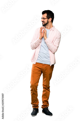 Full-length shot of Handsome man with beard scheming something over isolated white background