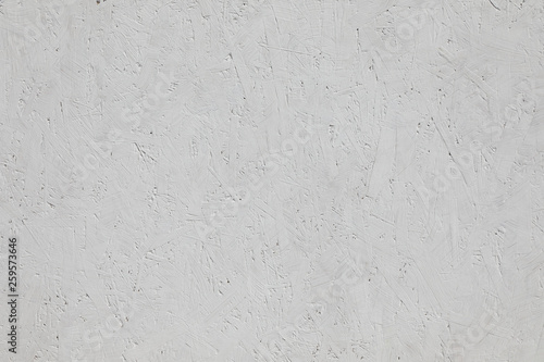 Background of textured wood chipboard , painted white .