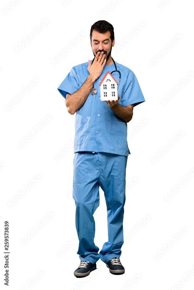 Surgeon doctor man holding a little house Surgeon doctor man holding a little house