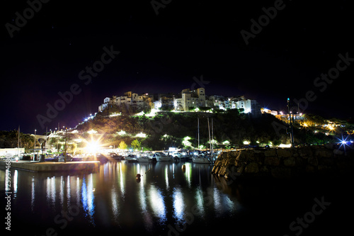 Stars  night and light on Sperlonga  Lazio. Italy. View from sea on the harbour and skyline.