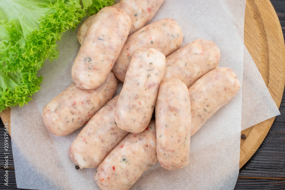 Fresh raw sausage on the wooden background, top view Fresh raw sausage on the wooden background, top view
