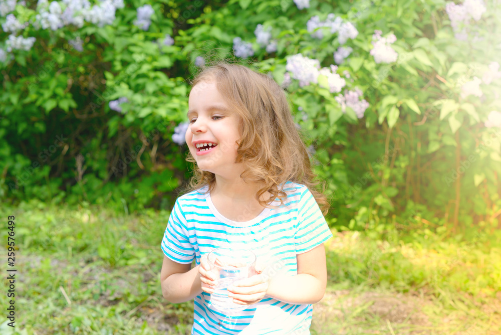child drinks water on a Sunny summer day. selective focus. child drinks water on a Sunny summer day. selective focus.