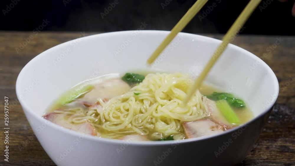Men eating red pork noodles, hot soup Men eating red pork noodles, hot soup