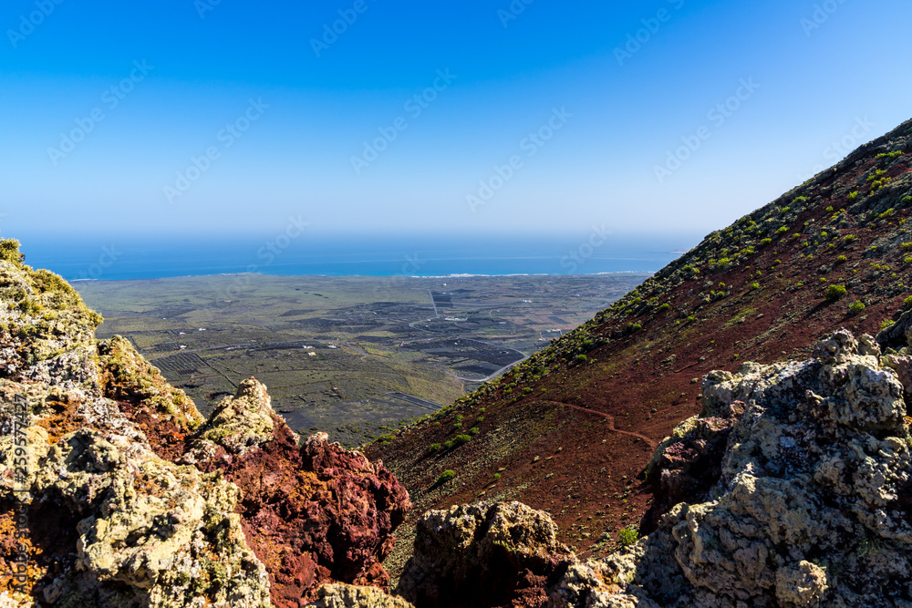 Spain, Lanzarote, Endless volcanic countryside behind volcanic lava rocks on top of volcano corona