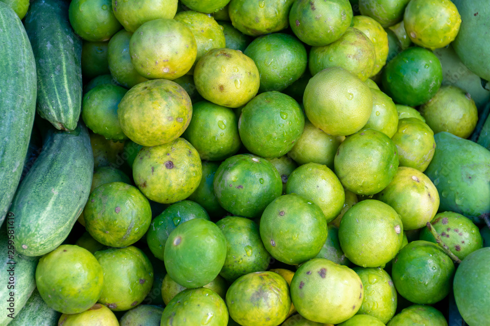 Close up fresh green limes on pile in the market. Close up fresh green limes on pile in the market.