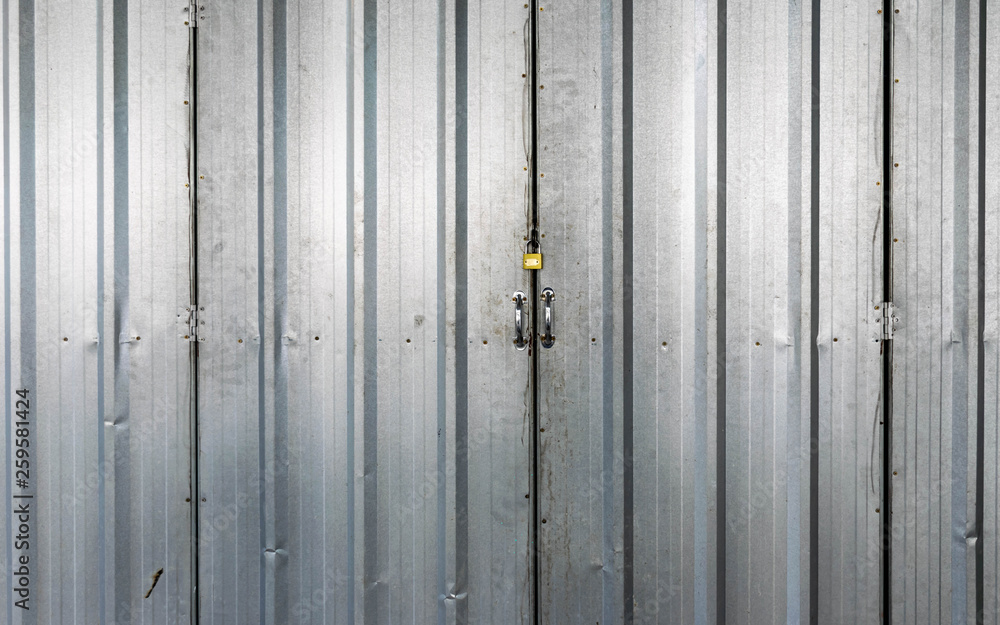 Texture of a metal iron door with a padlock locked Texture of a metal iron door with a padlock locked