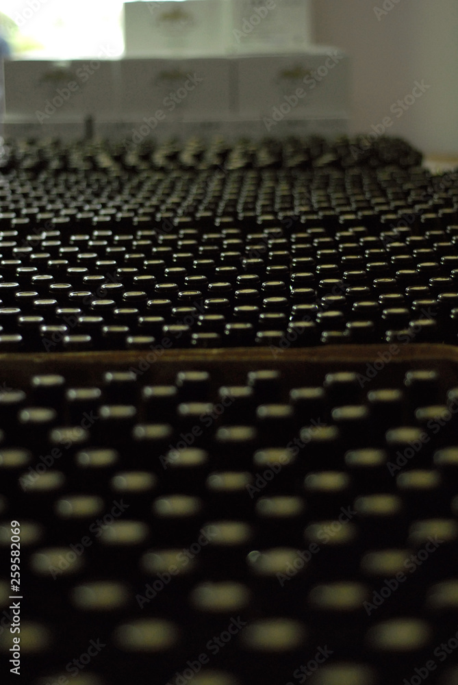 A lot of bottles of red wine in the warehouse. Boxes of wine at the factory. A lot of bottles of red wine in the warehouse. Boxes of wine at the factory.