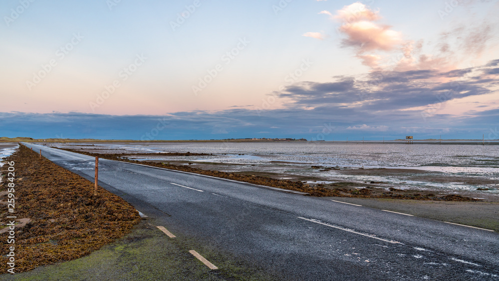 Evening sky and low tide on the road between Beal and Holy Island, Northumberland, England, UK Evening sky and low tide on the road between Beal and Holy Island, Northumberland, England, UK
