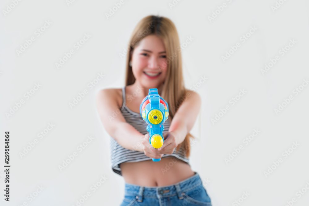 Asian sexy woman with gun water in hand on white background,Festival songkran day at thailand,The best of festival of thai,Land of smile Asian sexy woman with gun water in hand on white background,Festival songkran day at thailand,The best of festival of thai,Land of smile