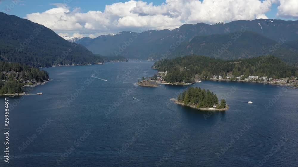 Aerial view over Burrard Inlet, ocean and island with boat and mountains in beautiful British Columbia. Canada. 4K. Aerial view over Burrard Inlet, ocean and island with boat and mountains in beautiful British Columbia. Canada. 4K.