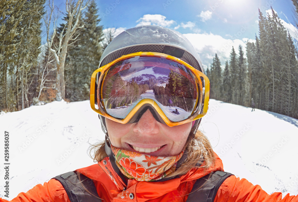 Happy woman taking selfie on winter  in Carpathian Mountains, Bukovel , Ukraine