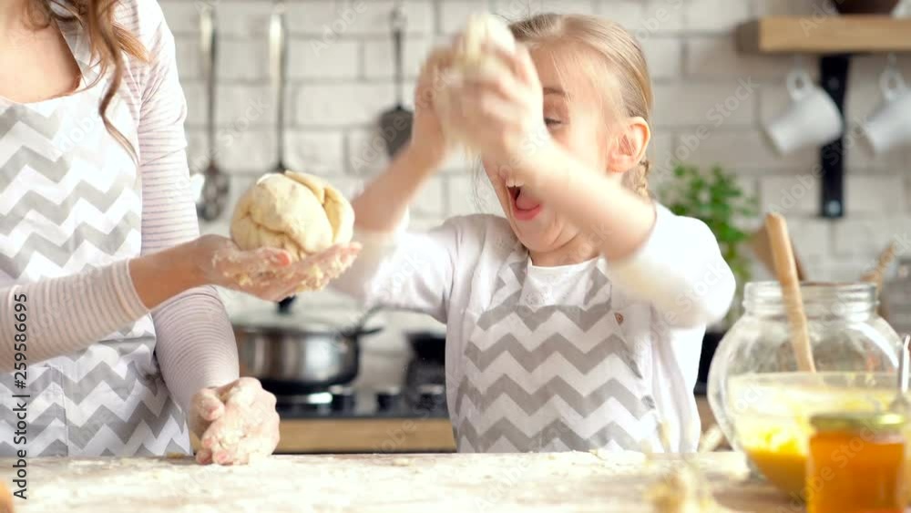 Mother and daughter having fun. Kneading dough. Mother and daughter having fun. Kneading dough.