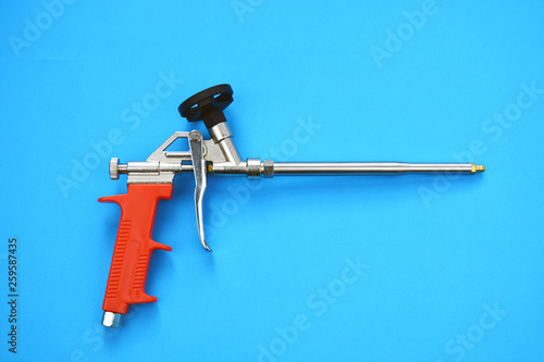 mounting foam sprayer gun pistol tool on blue background