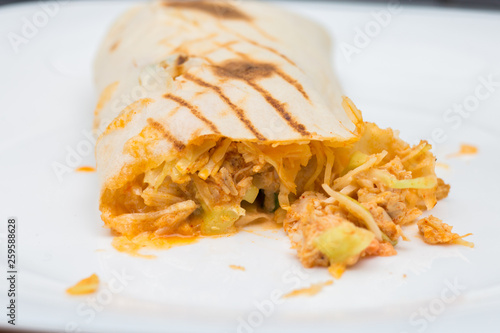 The cut shawarma in a lavash. Juicy stuffing of shawarma. Street food on a white background photo