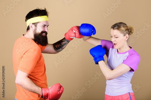 punching, sport Success. sportswear. Fight. knockout and energy. couple training in boxing gloves. Happy woman and bearded man workout in gym. training with coach. Make your competitive juices photo