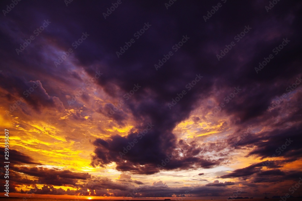 Burning sky and sea during sunset over the ocean of tropical island Ko Lanta, Andaman Sea, Thailand