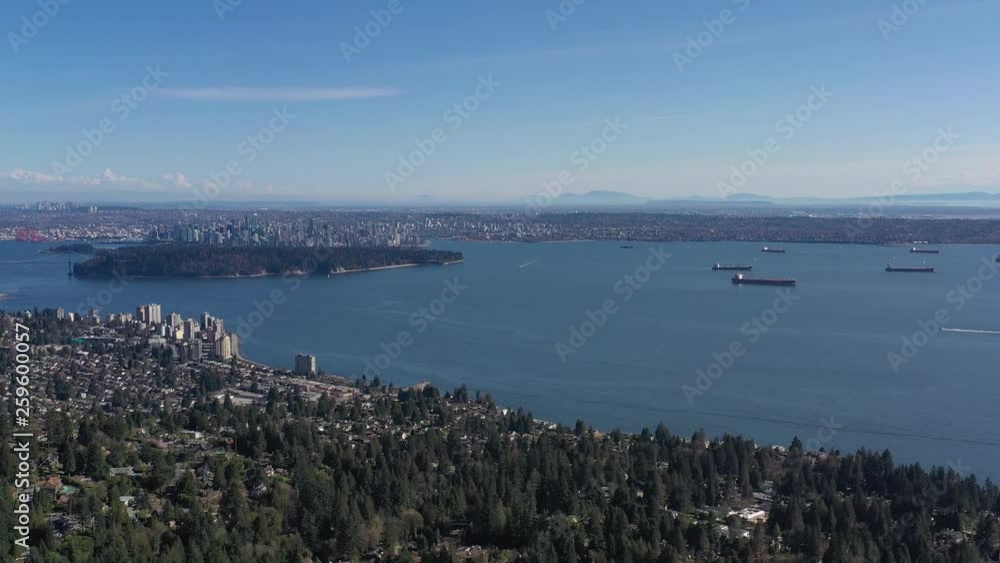 Aerial view over Burrard Inlet, ocean and island with boat and mountains in beautiful British Columbia. Canada. 4K. Aerial view over Burrard Inlet, ocean and island with boat and mountains in beautiful British Columbia. Canada. 4K.