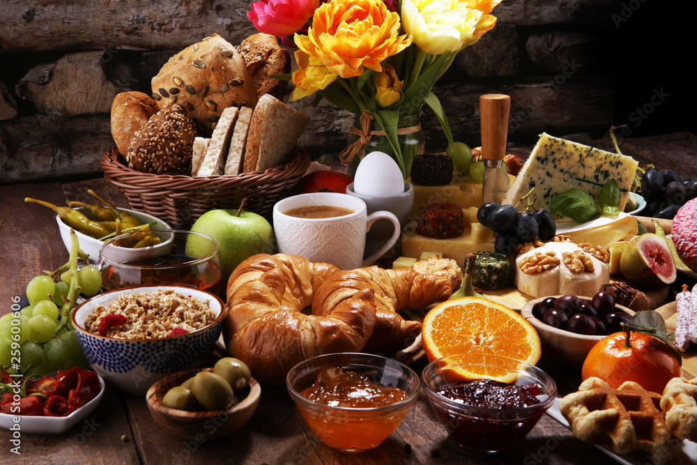 breakfast on table with bread buns, croissants, coffe and eggs breakfast on table with bread buns, croissants, coffe and eggs