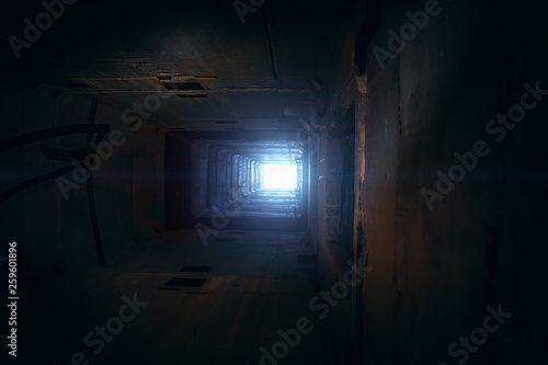 Light in end of old grungy concrete tunnel or tube or corridor  abstract way to hope concept in abandoned scary building