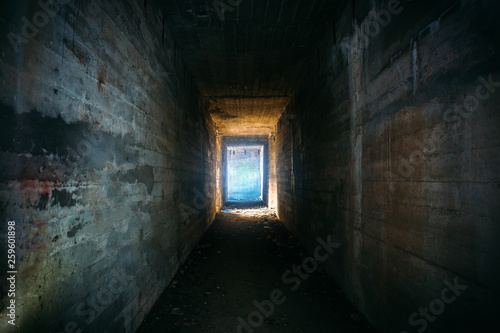 Light in end of old grungy concrete tunnel or tube or corridor, abstract way to hope concept in abandoned scary building