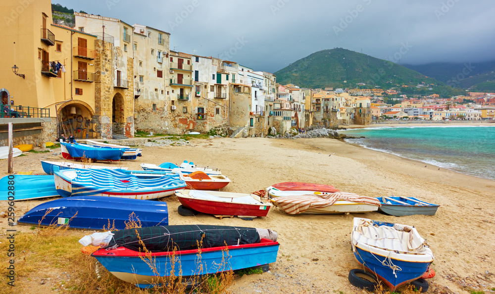 Boats and old houses by the sea in Cefalu