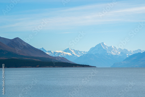 Scenic landscape panoramic view of the Lake Pukaki and Aoraki/Mount Cook on background. Tourist popular destination in South Island, New Zealand. Clear sky, sunny summer day. Travel concept.