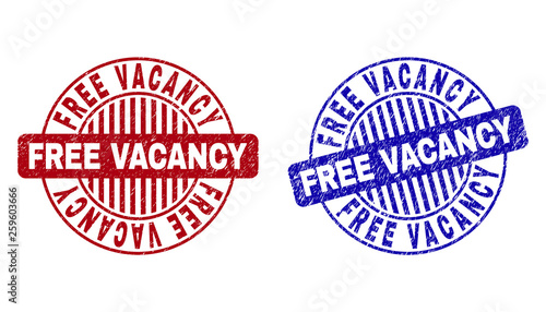 Grunge FREE VACANCY round stamp seals isolated on a white background. Round seals with grunge texture in red and blue colors.