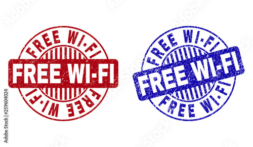 Grunge FREE WI-FI round stamp seals isolated on a white background. Round seals with grunge texture in red and blue colors. Vector rubber imitation of FREE WI-FI text inside circle form with stripes.