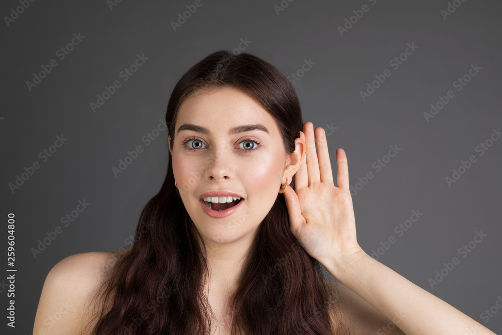 I can not hear you. Beautiful young positive girl with long brunette hair with a hand near the ear I can not hear you. Beautiful young positive girl with long brunette hair with a hand near the ear