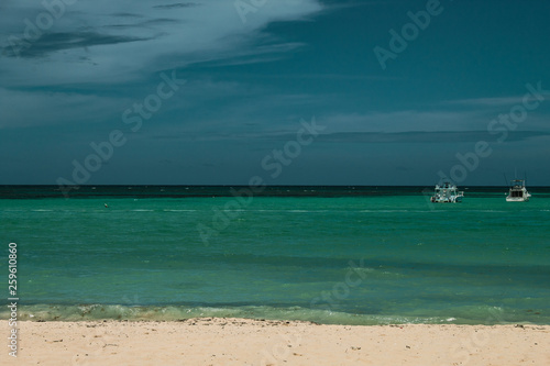 Fototapeta Naklejka Na Ścianę i Meble -  The amazing white sands and turquoise sea of Bavaro beach, Punta Cana. Vacation or Holiday concept