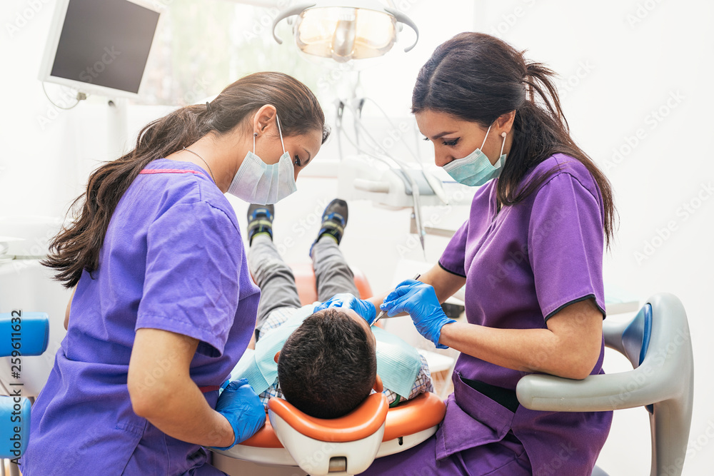 Dentists working in dental clinic Dentists working in dental clinic