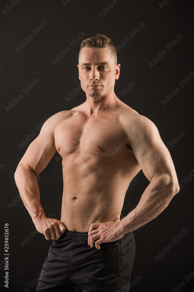 Fototapeta premium handsome muscular man on black background