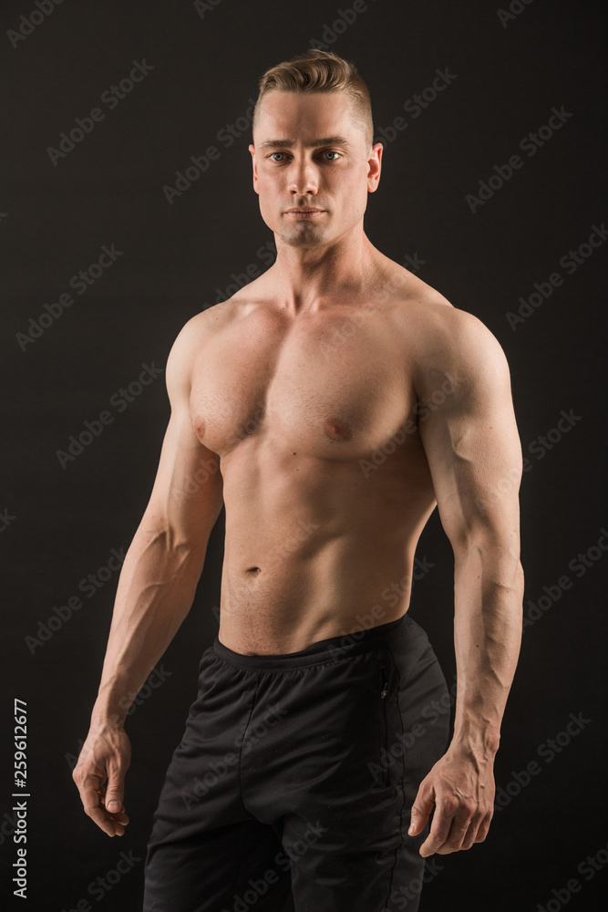 handsome muscular man on black background
