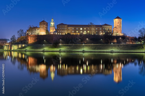 Krakow, Poland. Wawel Hill with Wawel Royal Castle and fragment of Wawel Cathedral at dawn. View from the bank of Vistula river.